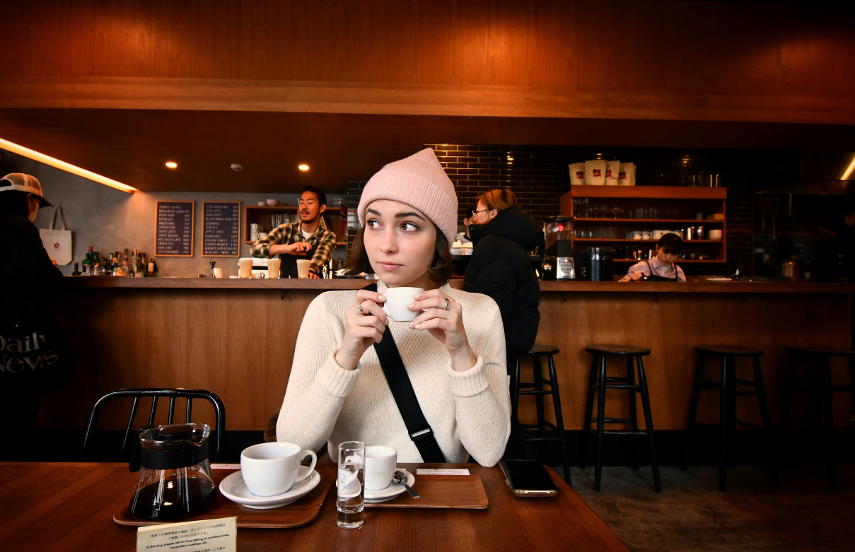 beauty school student studying at coffee shop in los angeles