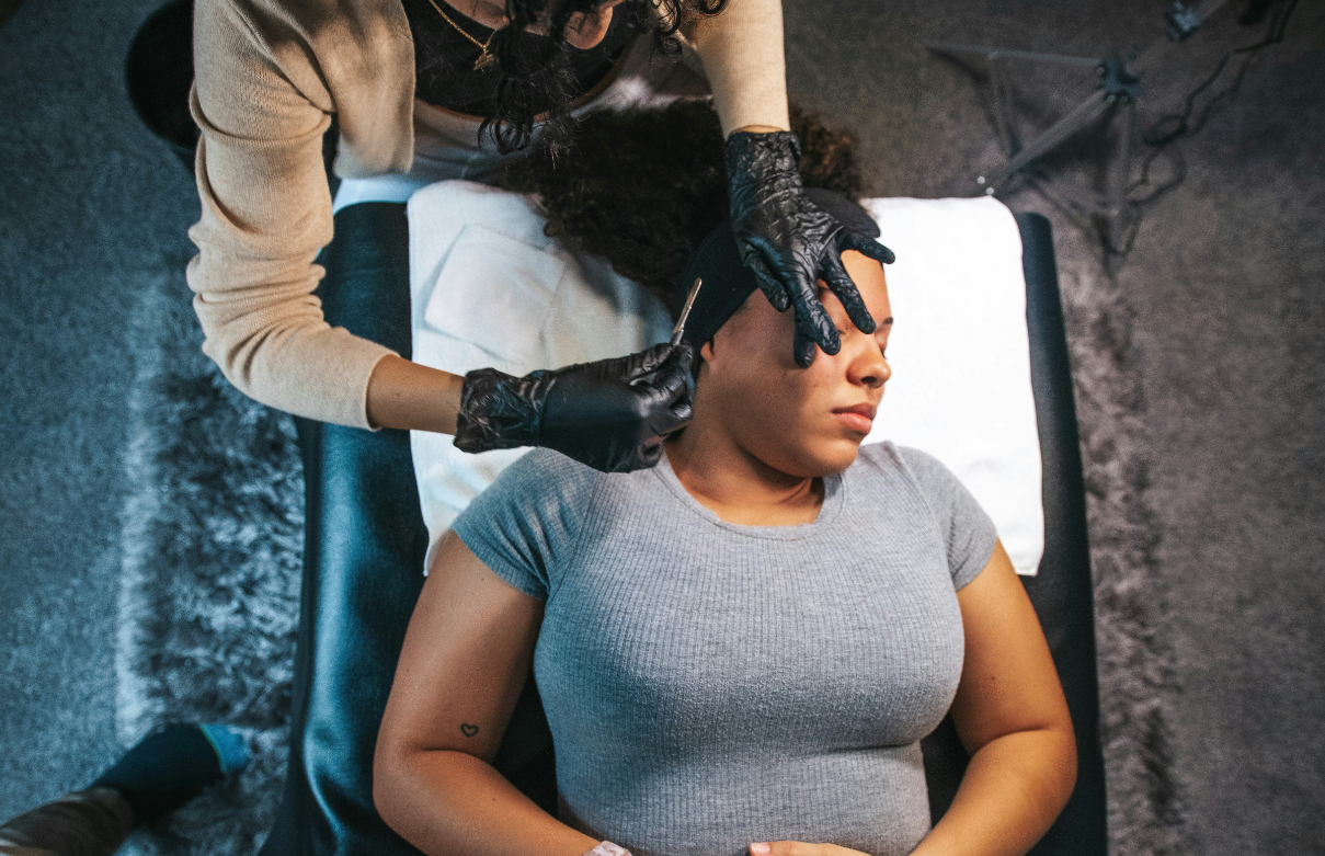 Esthetician student giving a facial during evening class at Beyond 21st Century Beauty Academy