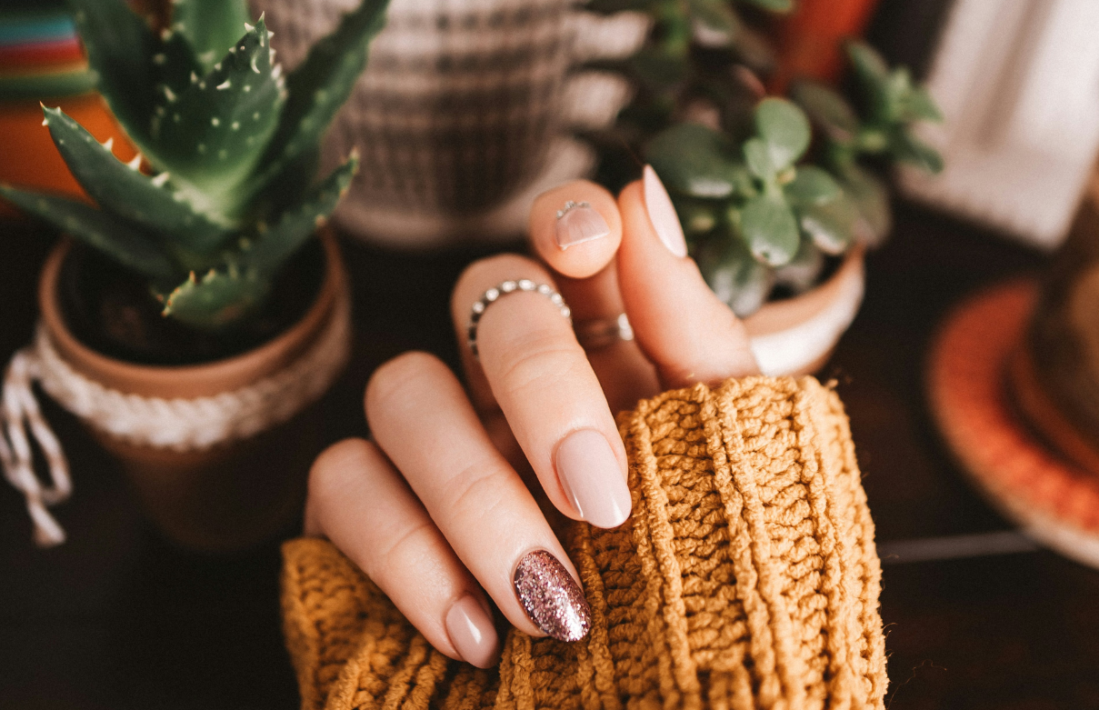 Nail technician student practicing Aprés Gel-X application on a client during evening class at a California beauty school