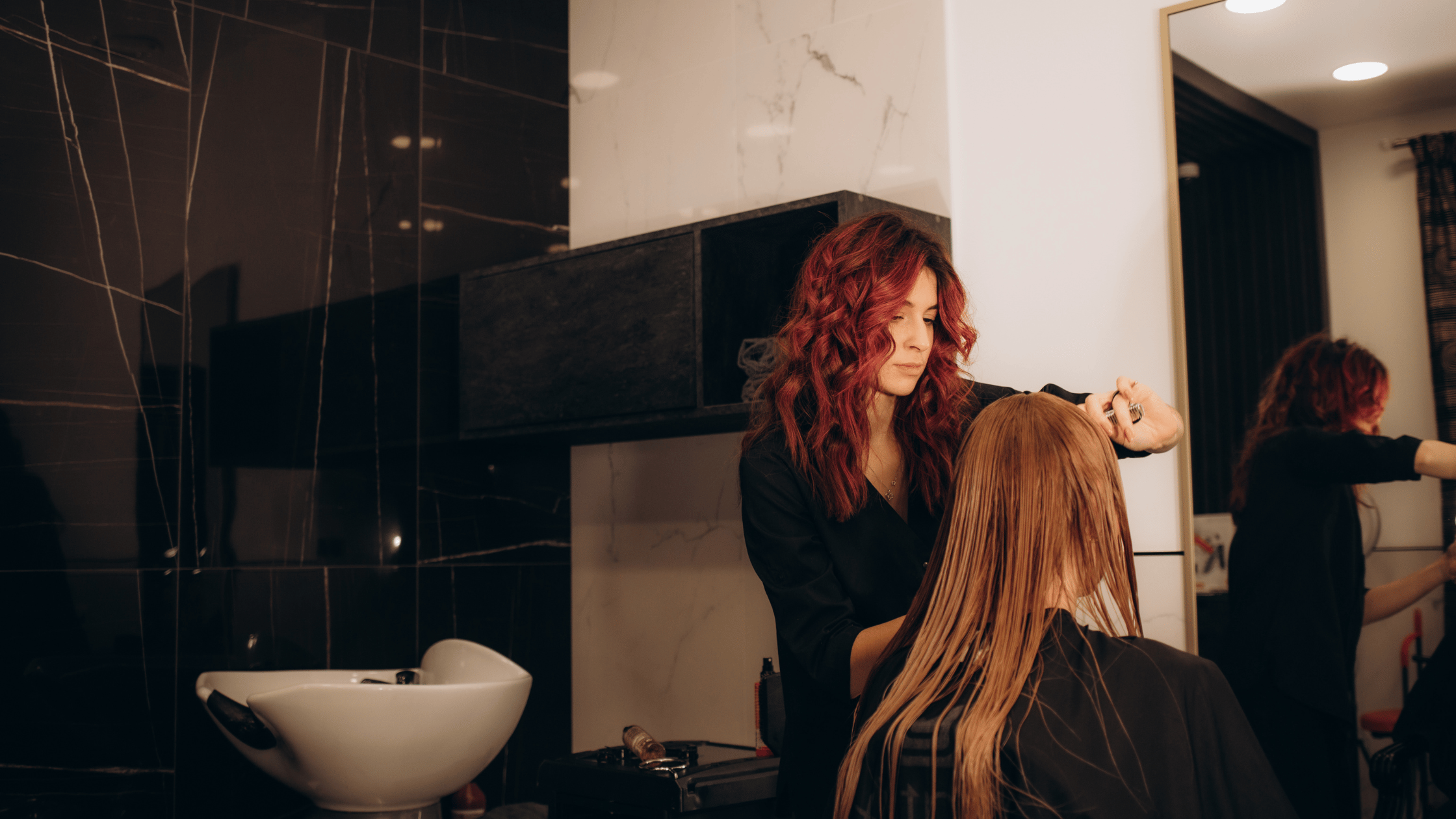 Cosmetology student practicing a balayage color technique during daytime training at Beyond 21st Century Beauty Academy in Santa Fe Springs