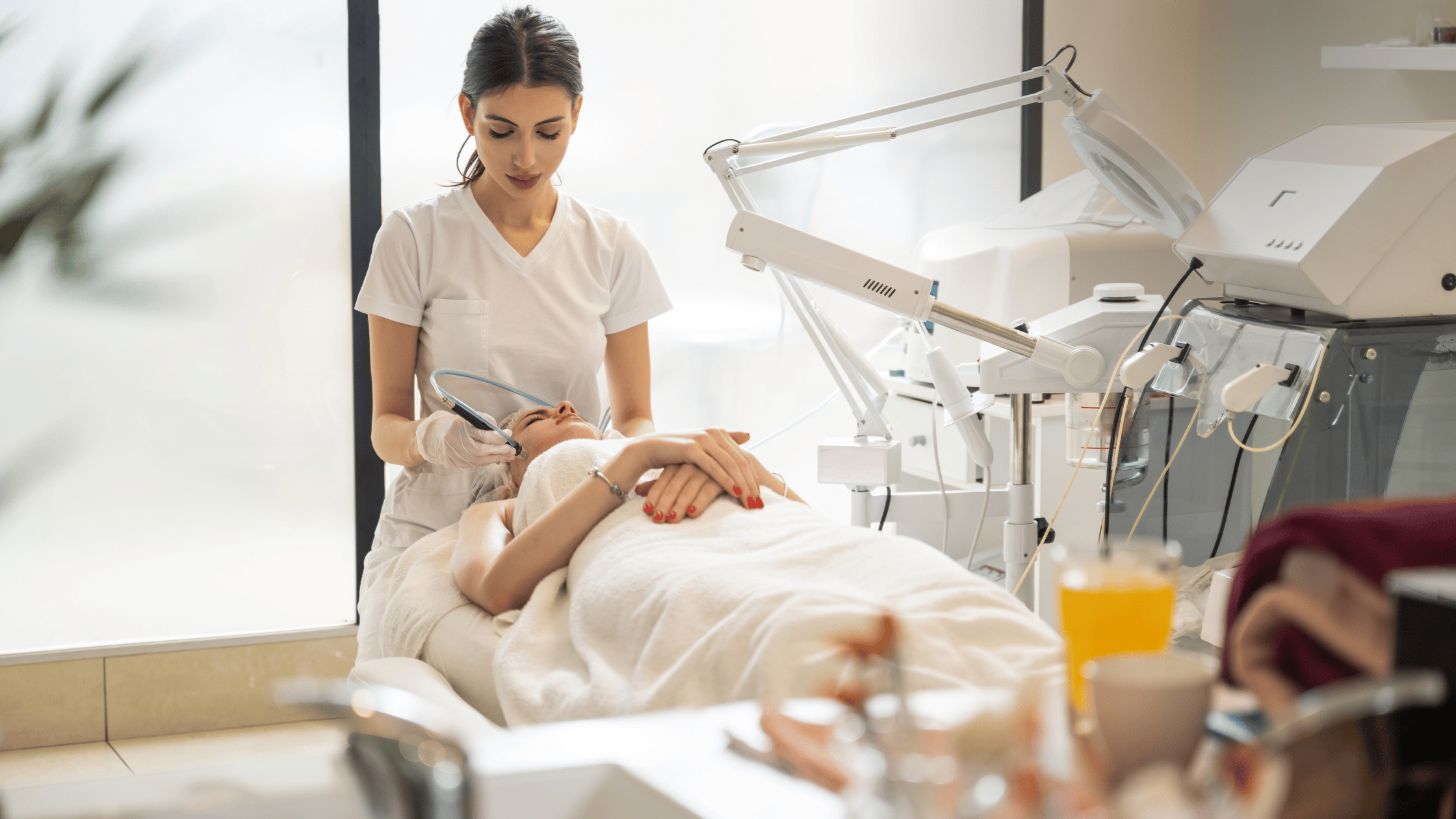 Esthetician consulting with a client about skincare treatment in a medical spa setting