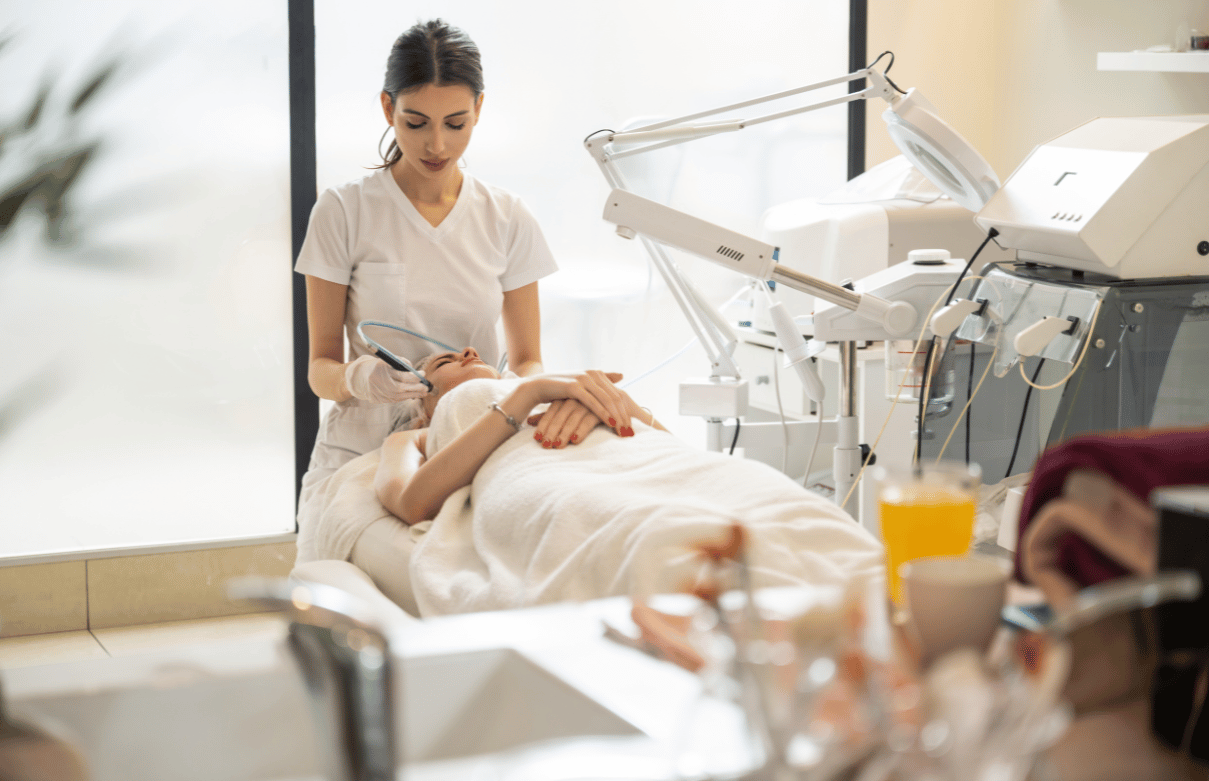 Esthetician consulting with a client about skincare treatment in a medical spa setting