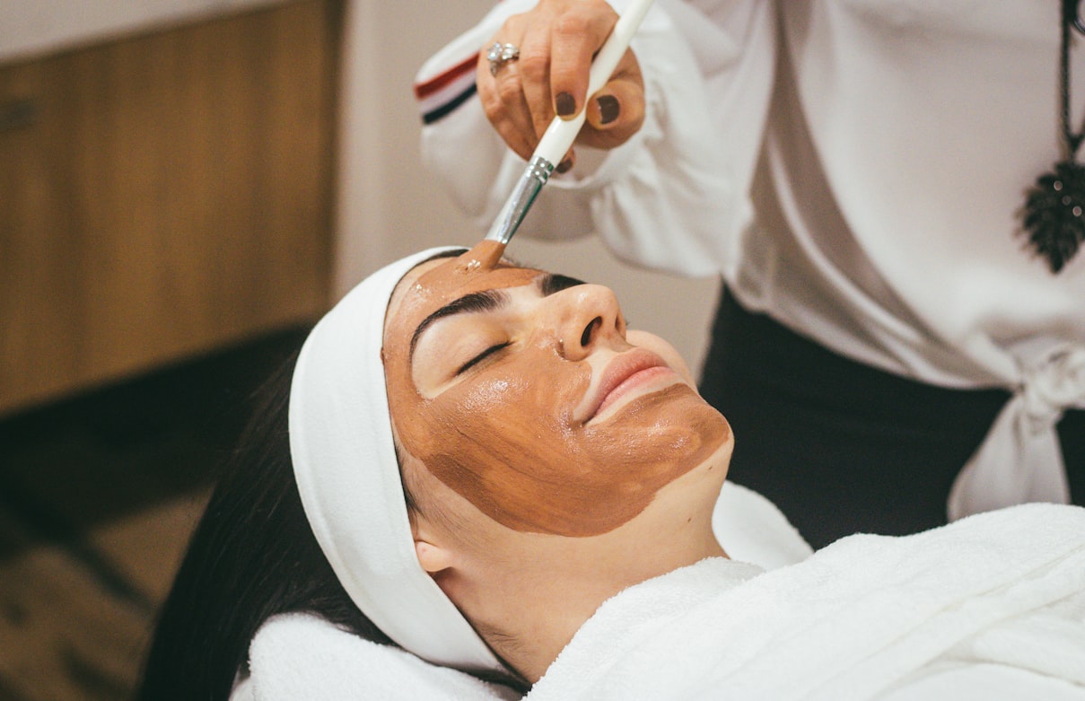 Esthetician student checking her class schedule between facial treatments at a California beauty school
