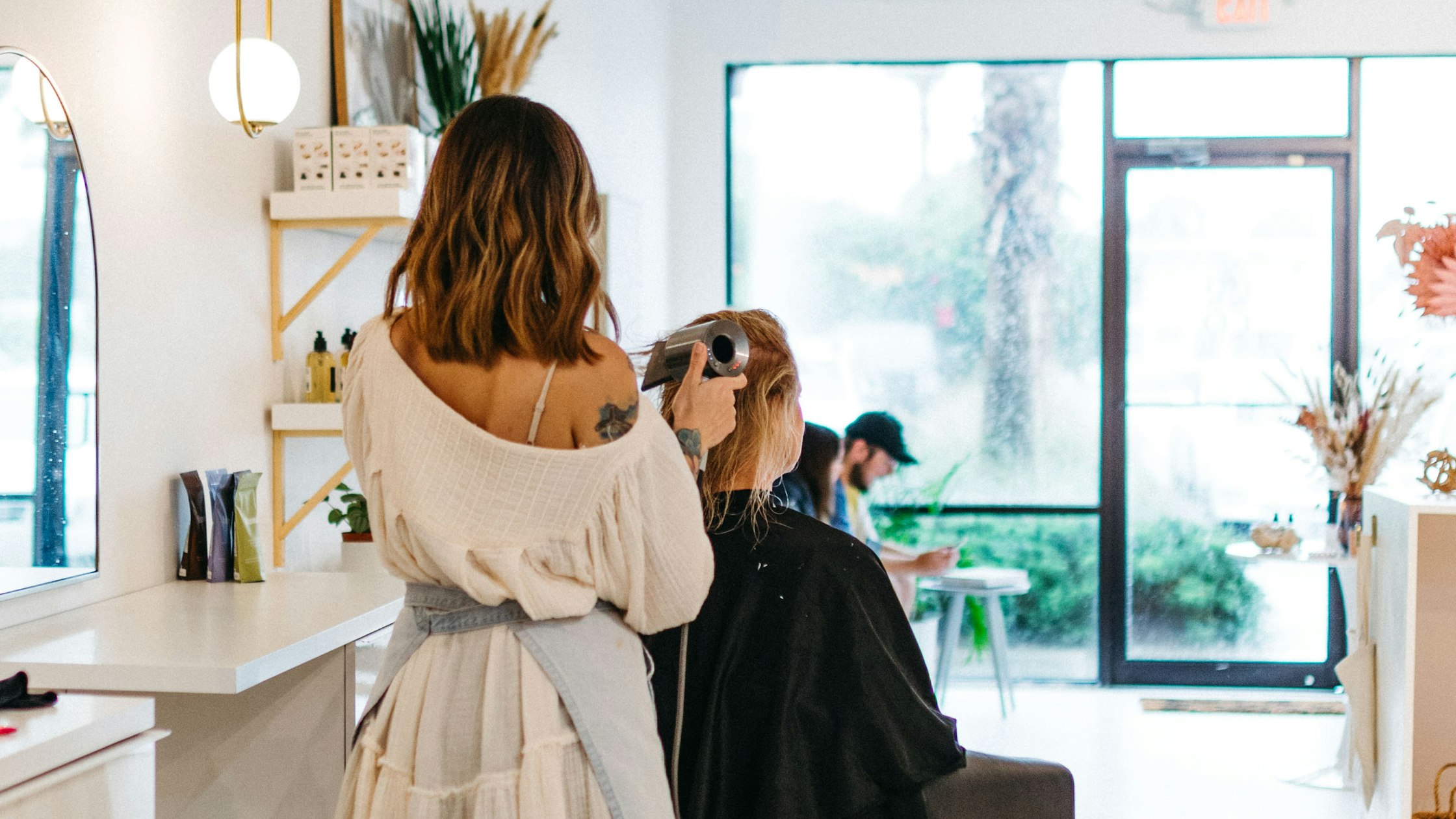 Cosmetology student practicing hair styling during daytime class at a hair school near Los Angeles