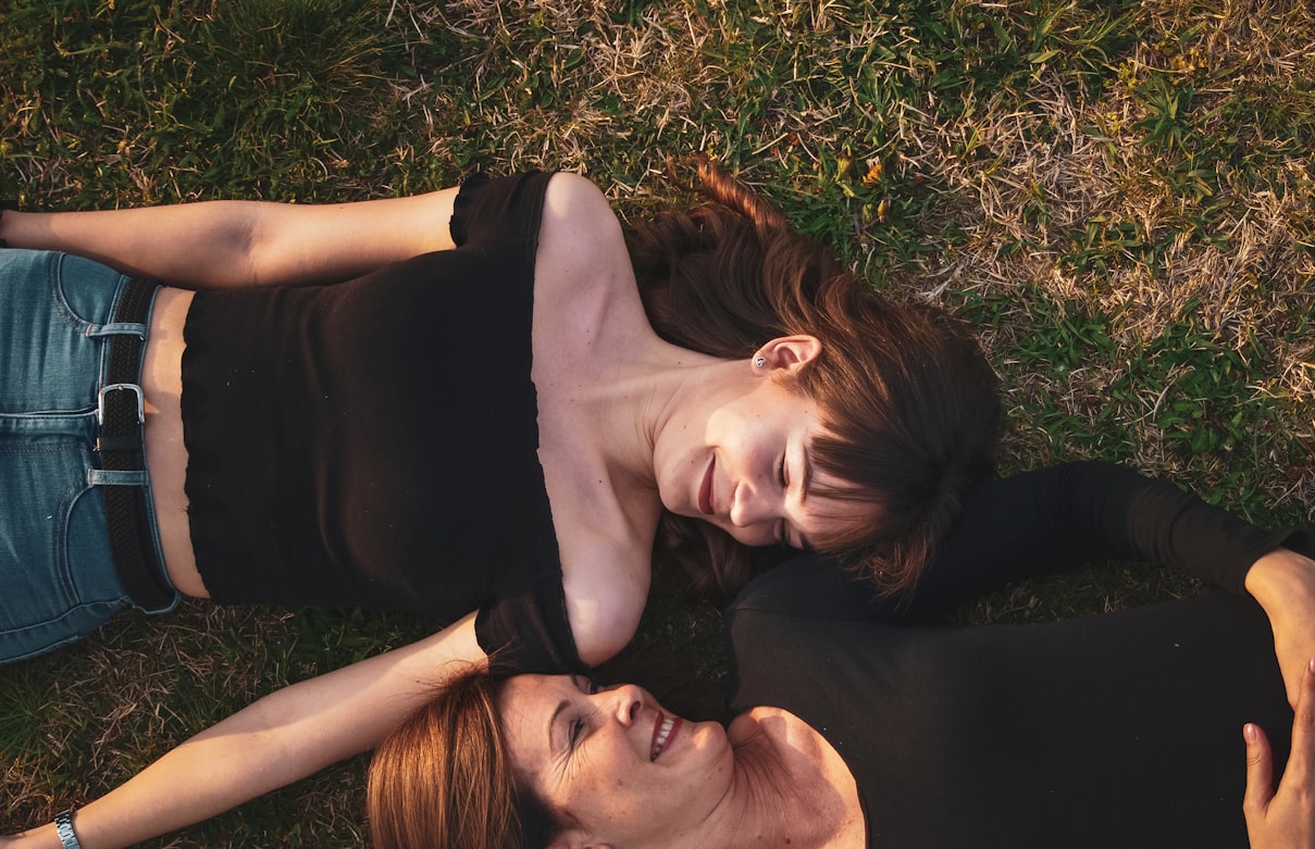 Young woman relaxing on the grass, taking a break from FAFSA paperwork