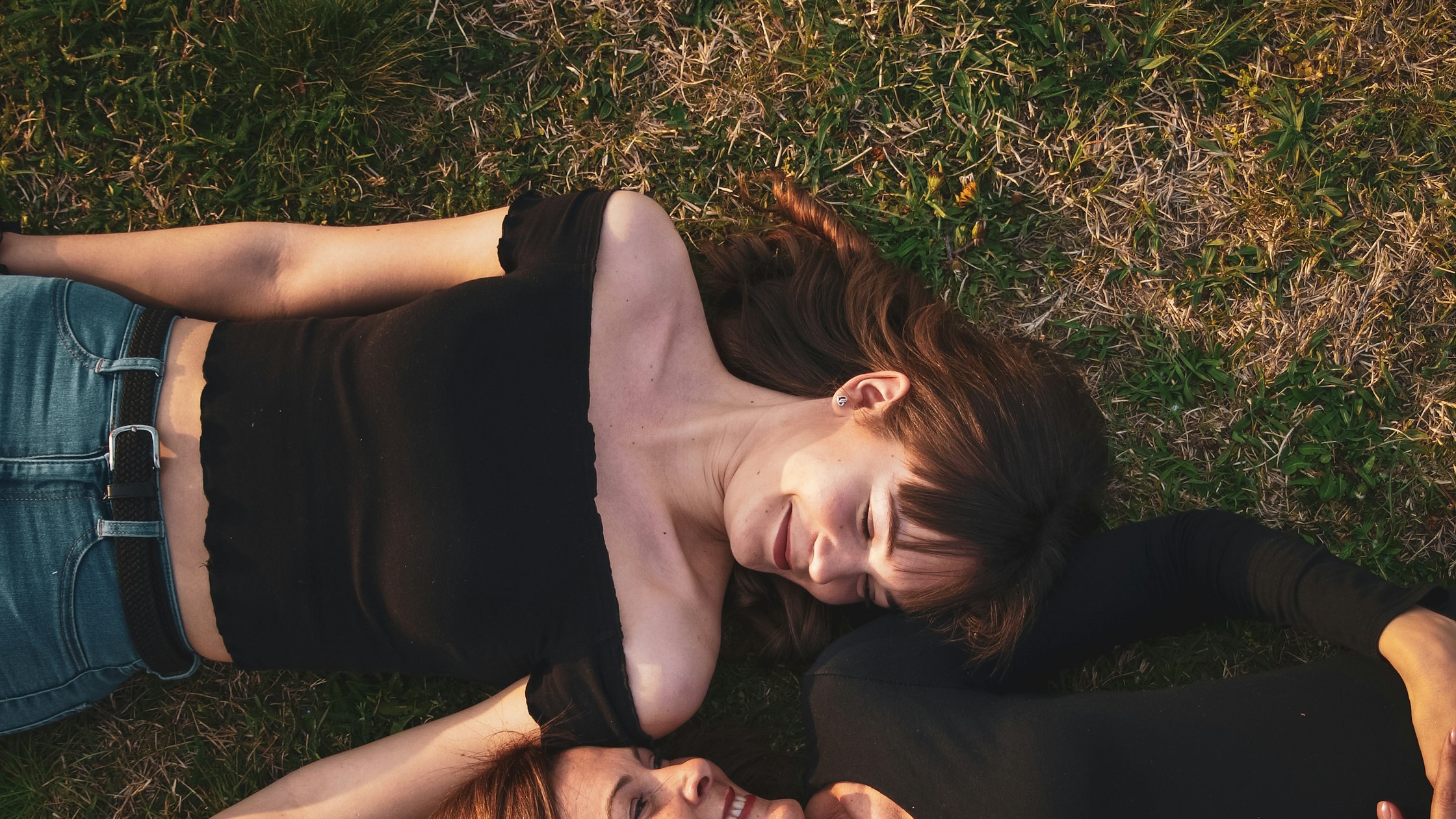 Young woman relaxing on the grass, taking a break from FAFSA paperwork