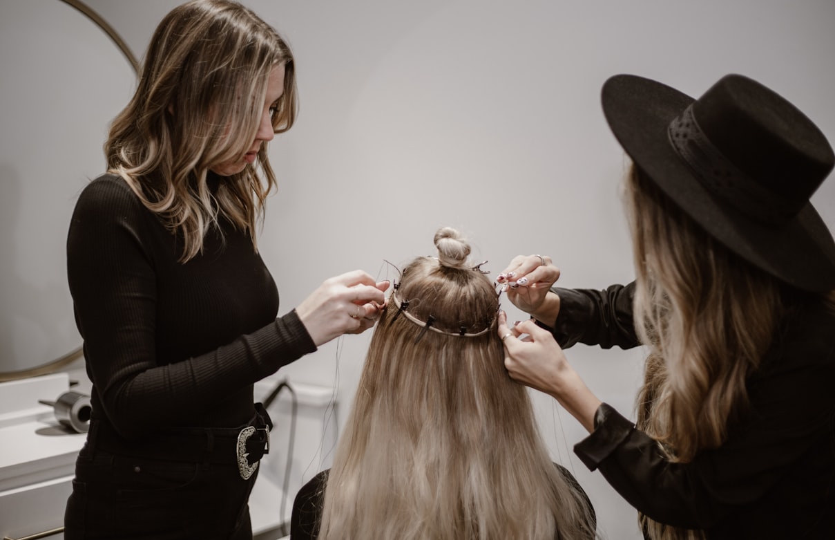Stylist styling a client's hair in a salon, the hands-on training at the heart of cosmetology school