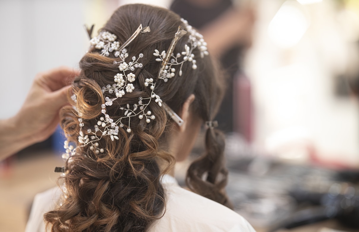 Woman in a white shirt with her hair tied back during a beauty service appointment in California