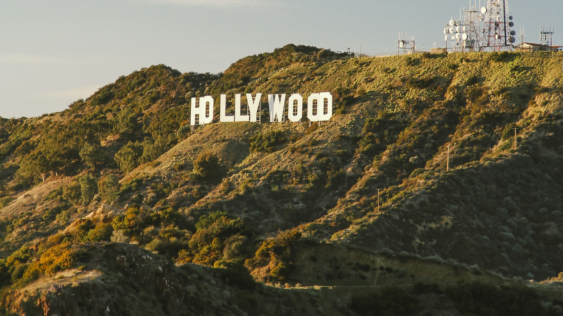 Hollywood sign on a Los Angeles hillside, where film and TV hair and makeup careers are built