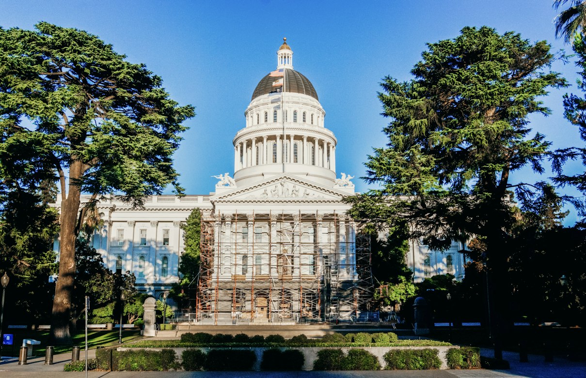 The California State Capitol building in Sacramento under a blue sky