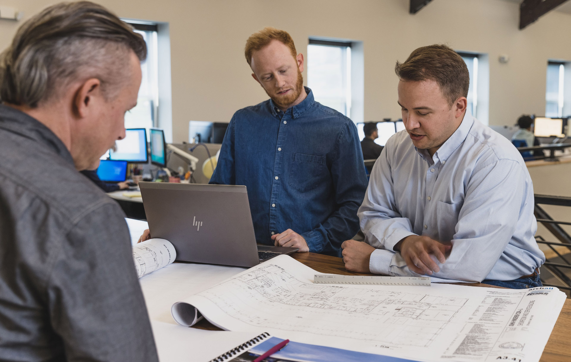 Architects at archall architects reviewing construction documents