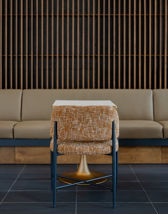 Chair with table and booth seating in multi-family lobby