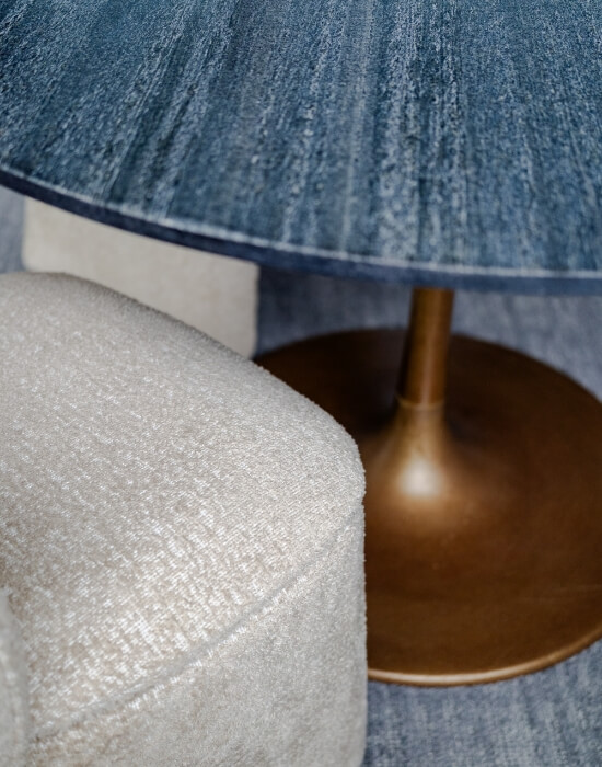 Blue table with gold base and white sofa