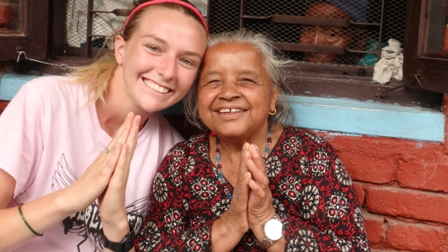 A Royal Servant and a local, posing for a picture.