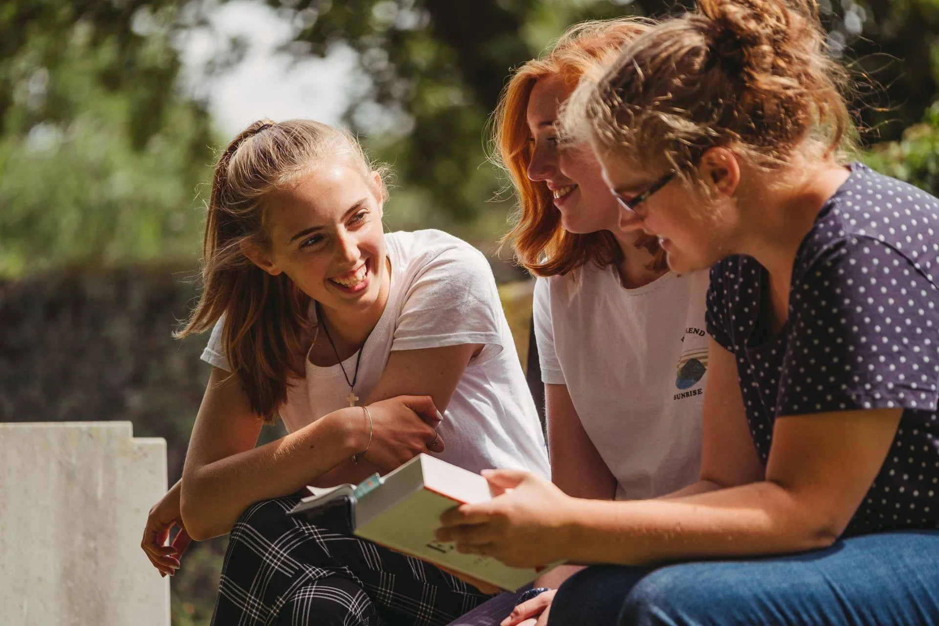 Three students laugh together