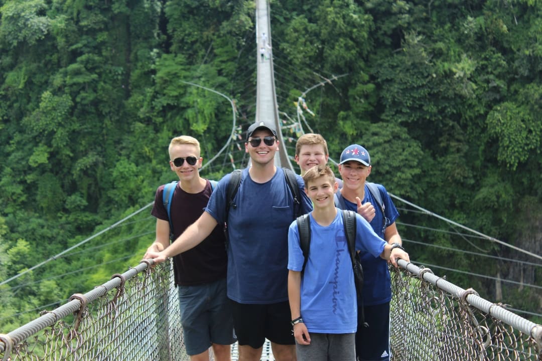 A group of Royal Servants on a rope bridge in Nepal.
