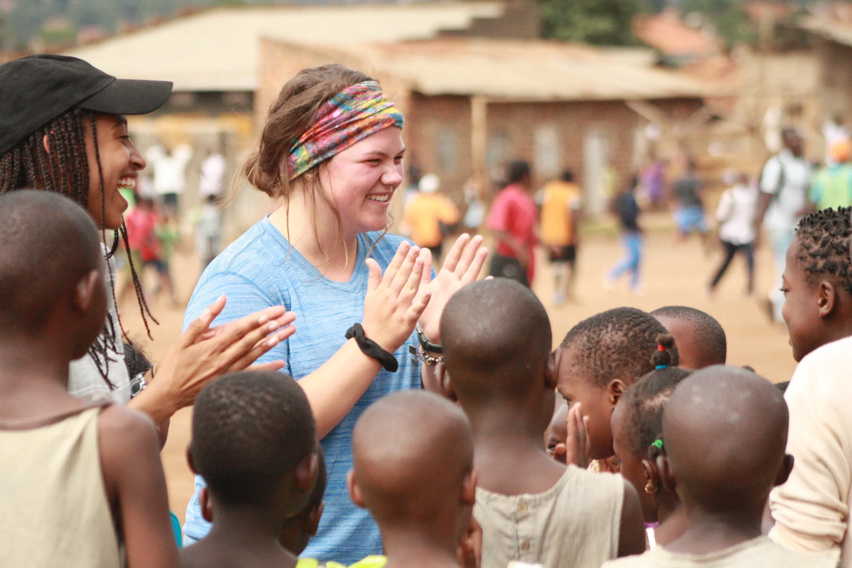 A Royal Servant playing games with a group of Kenyans.
