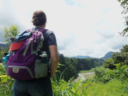 Someone with a backpack looking out at a ravine in Nepal