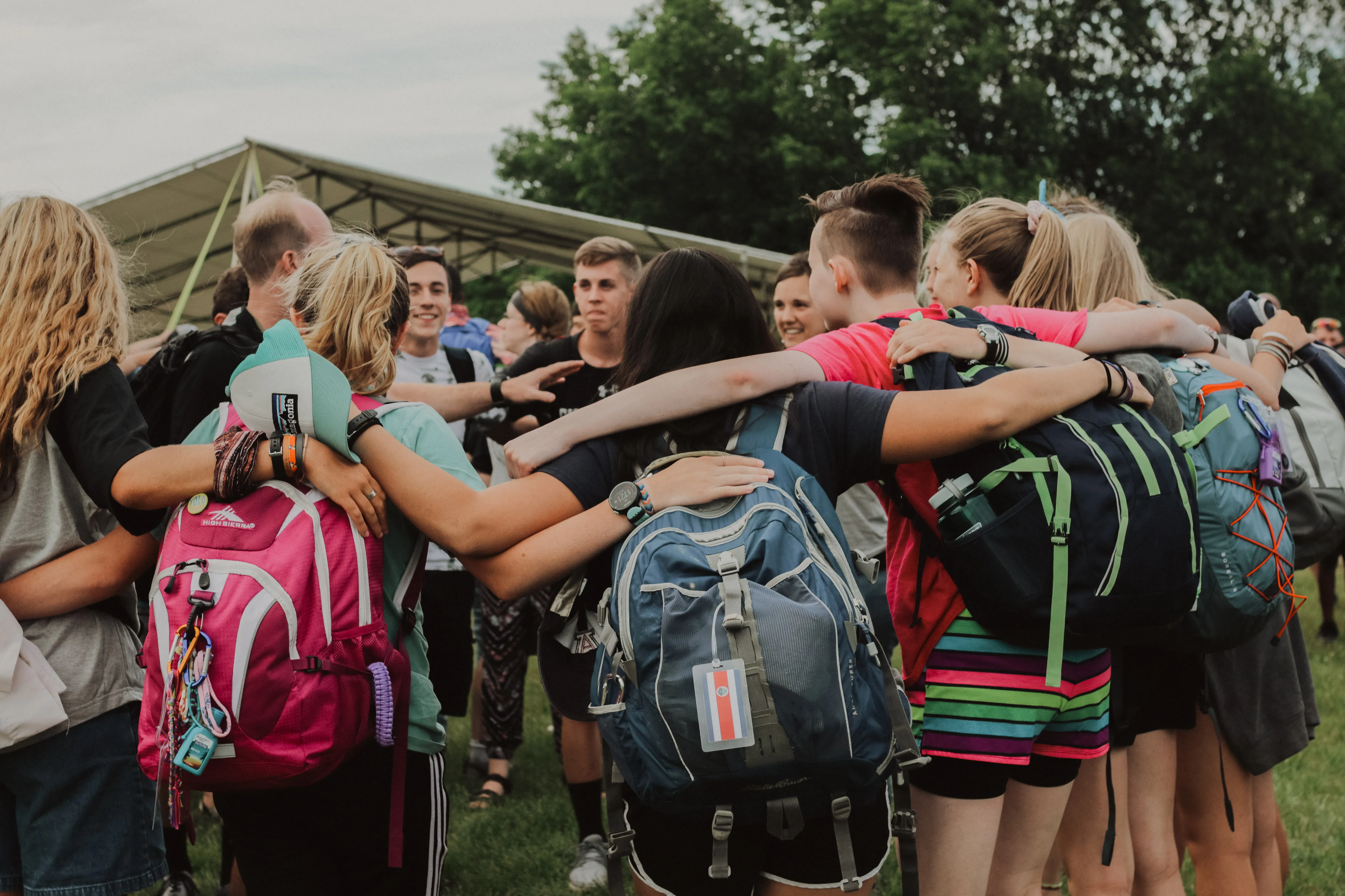 A group of people hugging and praying.