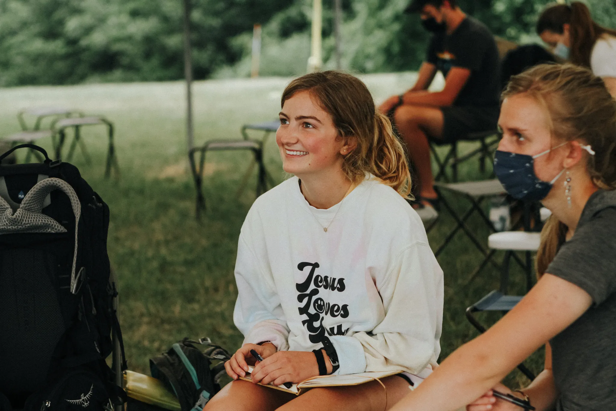 A group of Summer Staff, sitting around on stools.