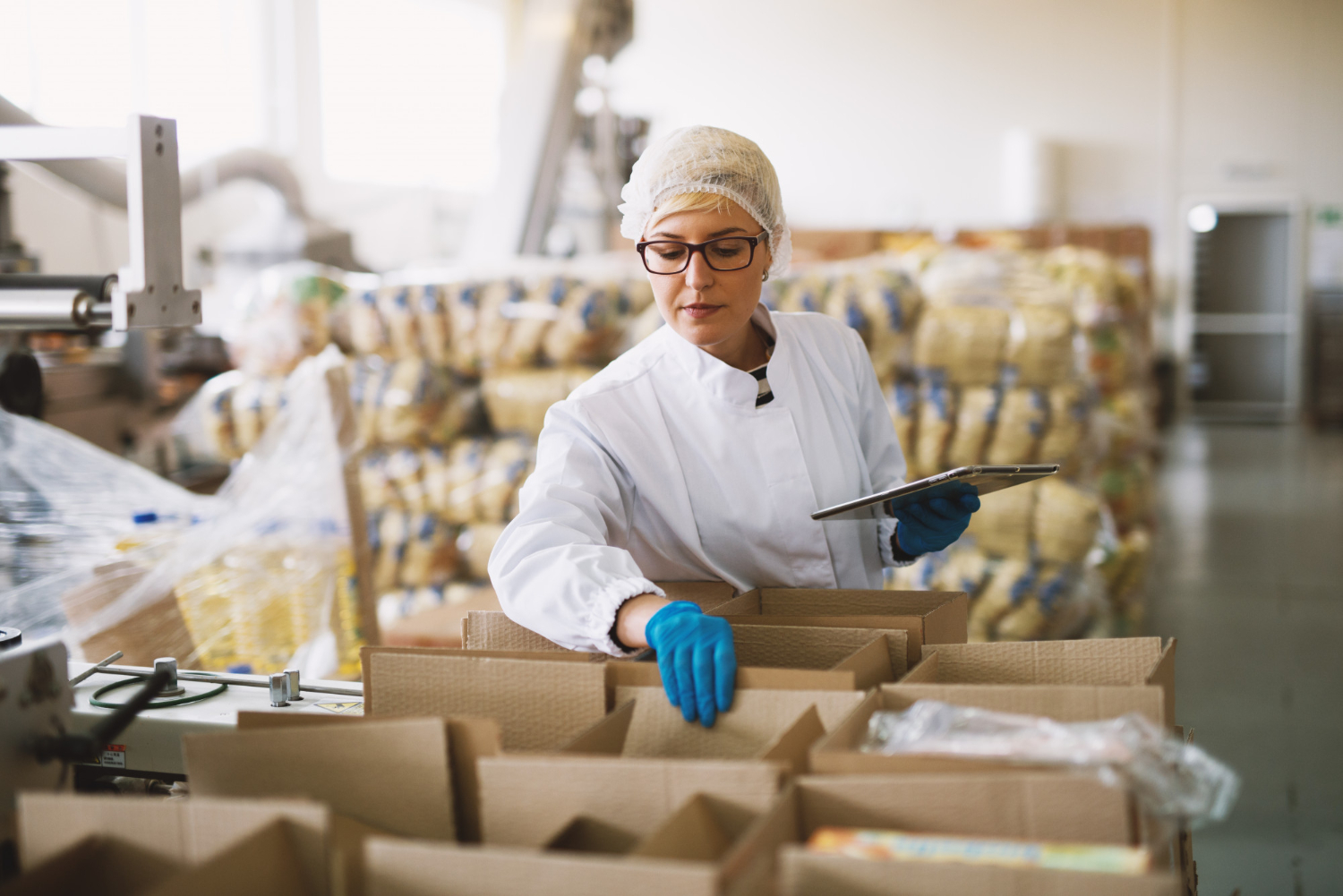 Alt text: A woman is checking packages that are ready to be delivered.