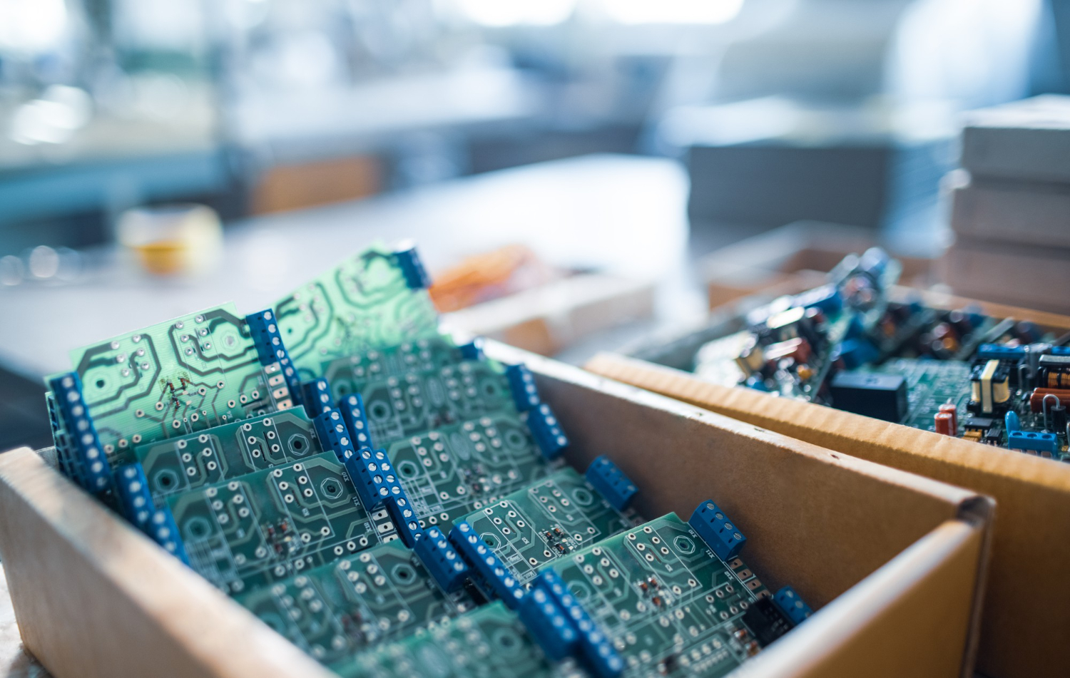 Alt text: Green embedded microcircuits inside boxes for packaging.