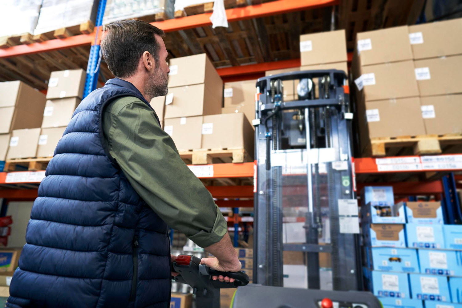 Alt text: Man operating a forklift in a warehouse