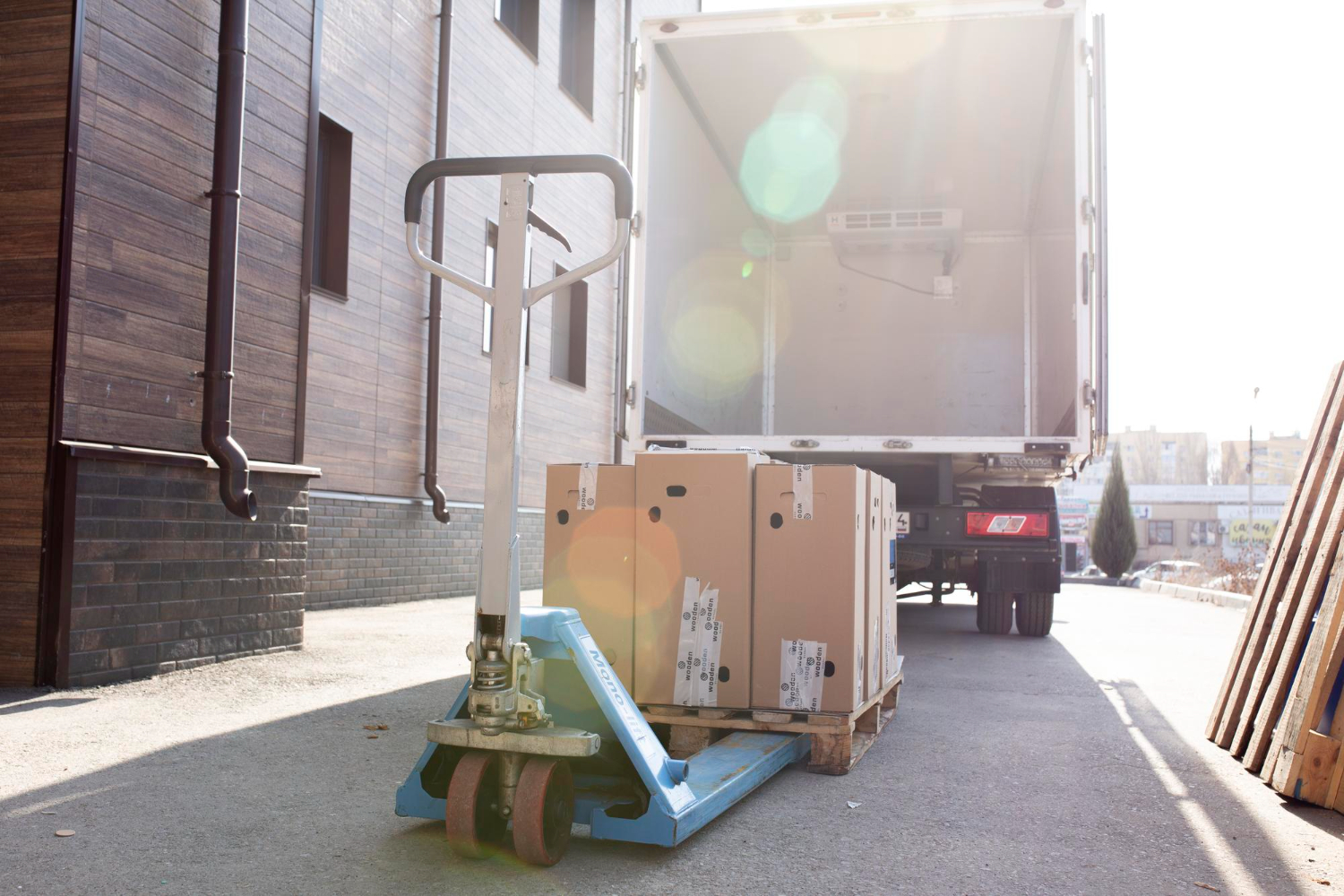 Alt text: Loading some cardbox cargo in empty white van truck