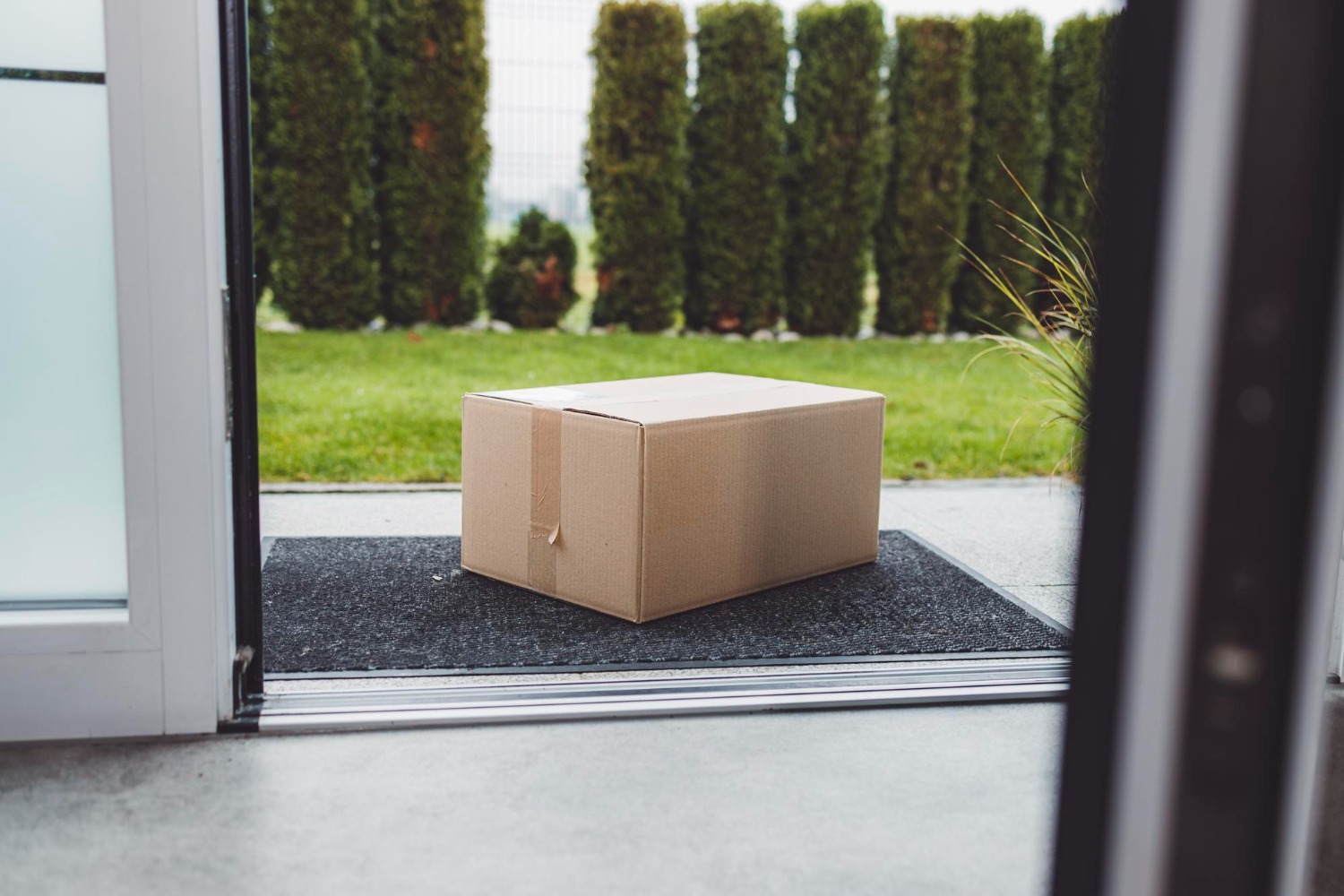 Alt text: A box placed on the doormat of a house