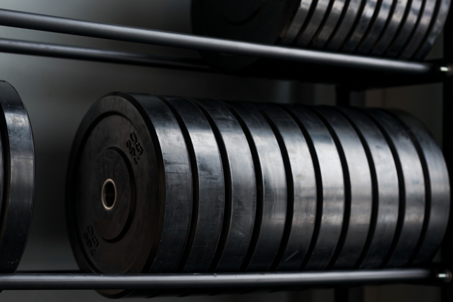 Alt text: Barbell weights on rack