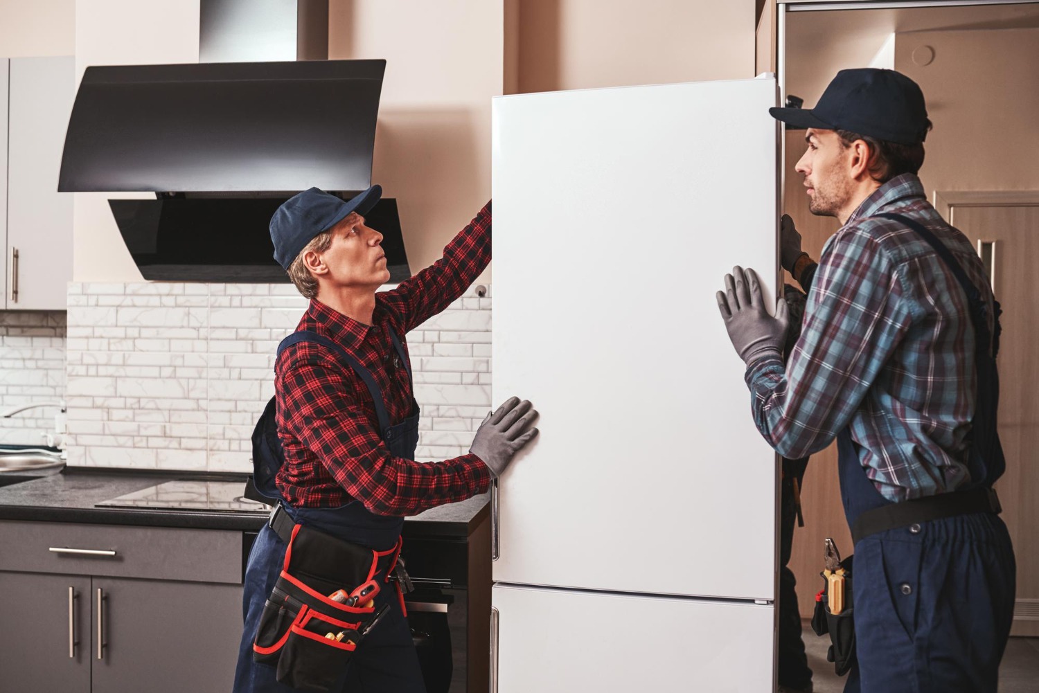 Alt text: Two people are setting up a fridge.