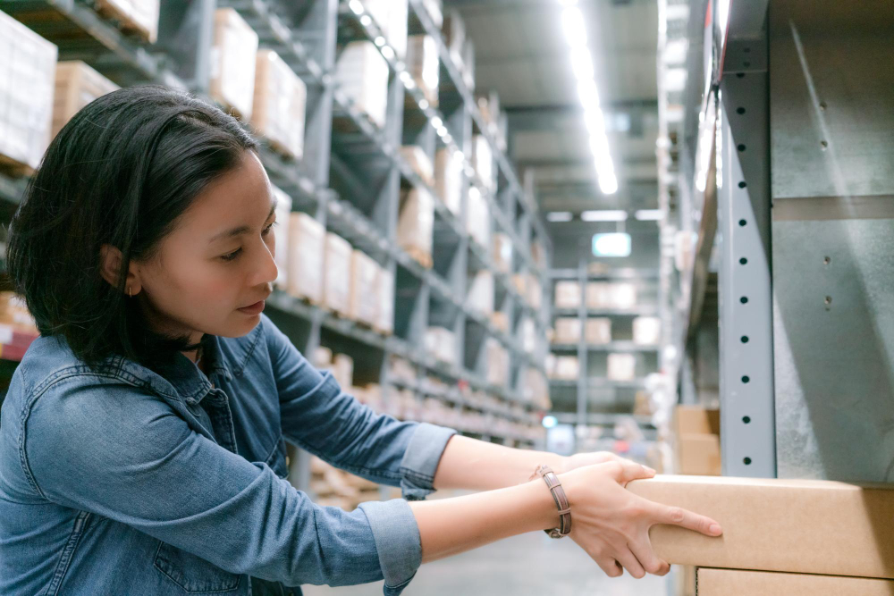 Alt text: Asia worker in warehouse international export or import business concept