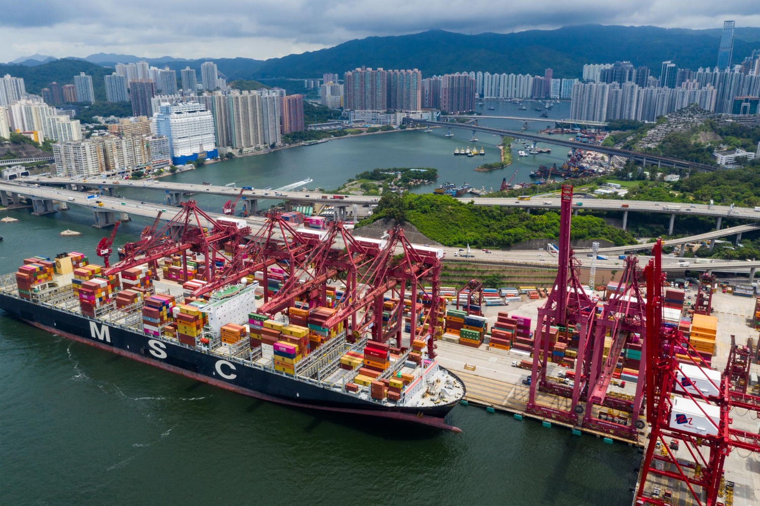 Alt text: An MCS container ship is docked at a port in Hong Kong.