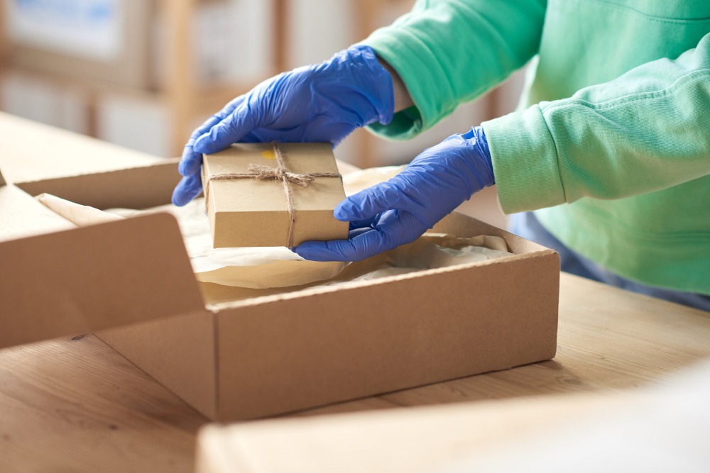 Alt text: Beauty subscription boxes and skincare products being prepared for packing