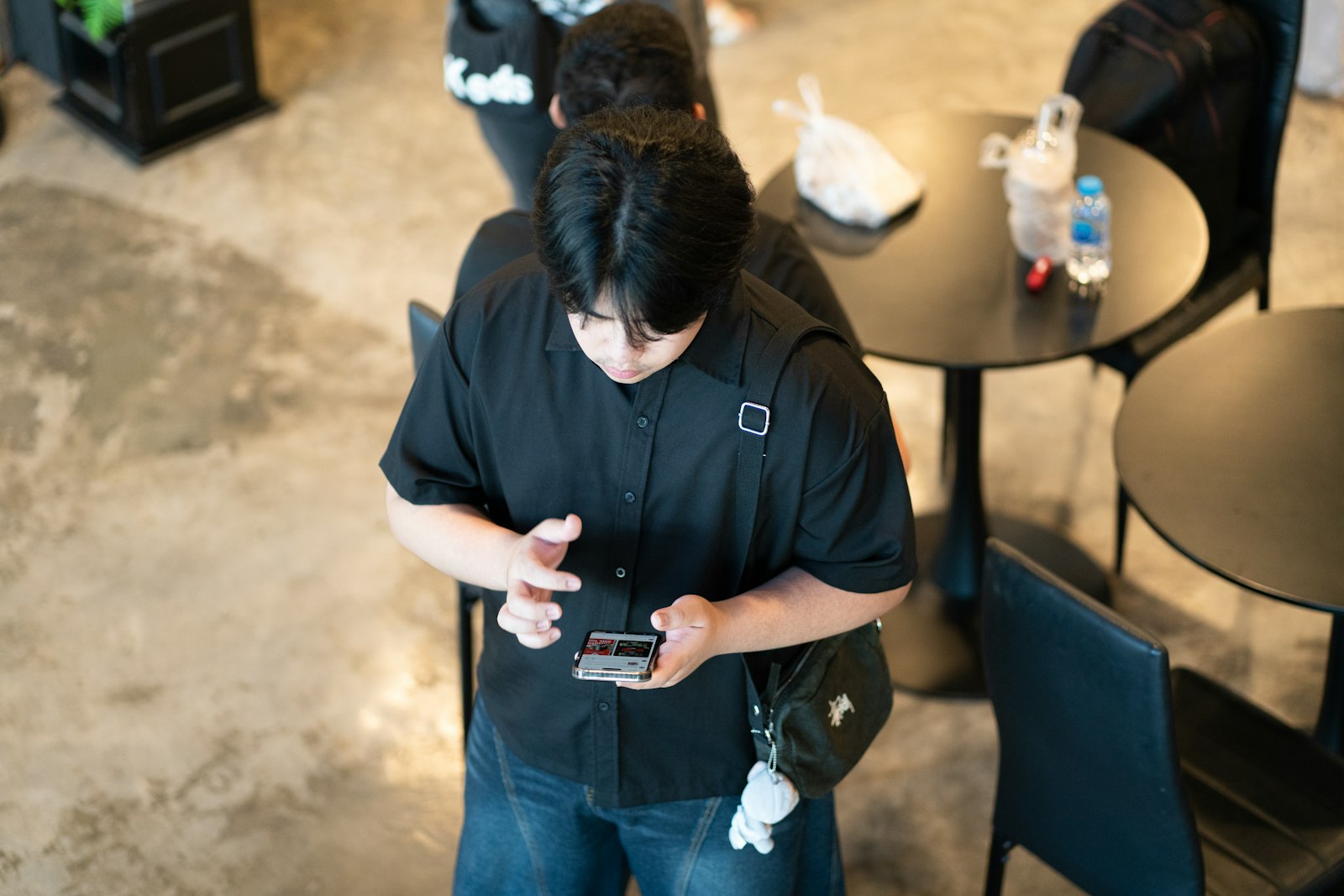 A person using a phone indoors