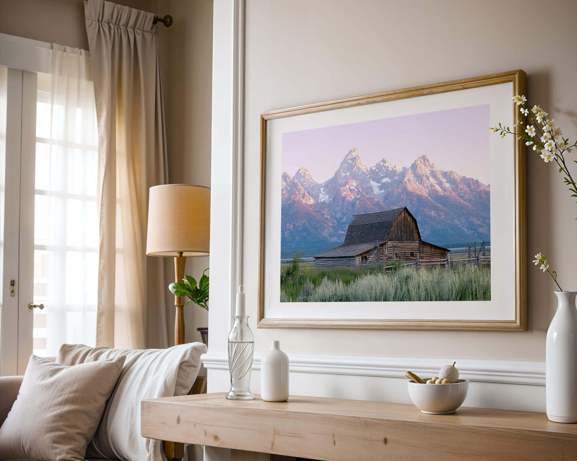 A framed photo of a barn in Grand Teton National Park over a fireplace