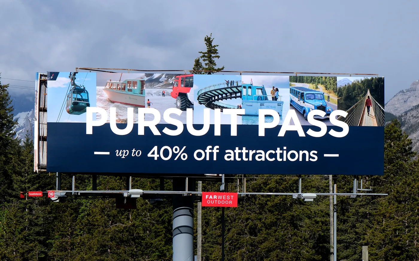 Billboard advertising Pursuit Pass offering up to 40% off attractions, showing images of gondola, boat, snow vehicle, spiral bridge, boat tour, vintage bus, and suspension bridge.