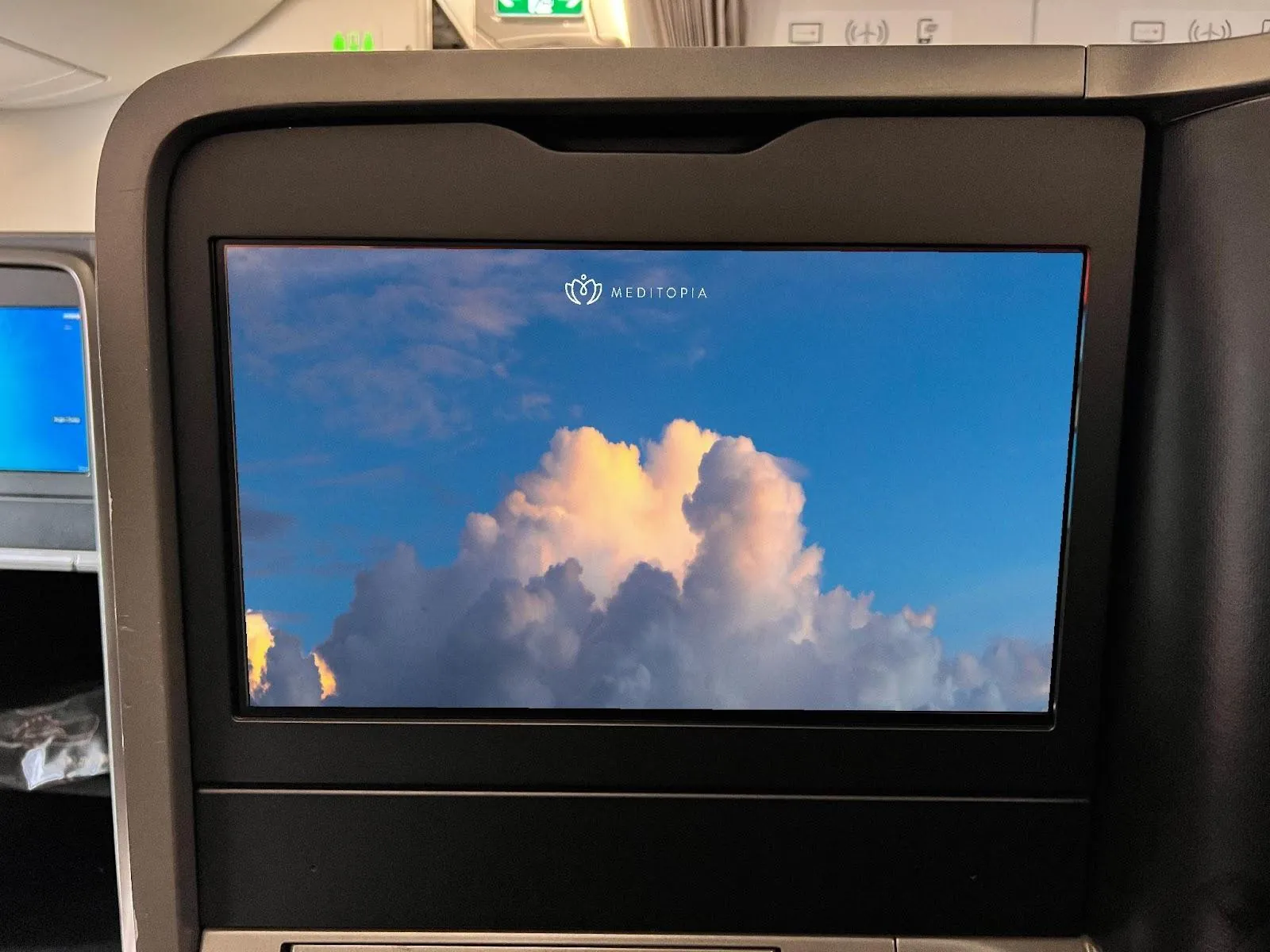 Meditopia content on a Turkish Airlines seatback screen showing clouds