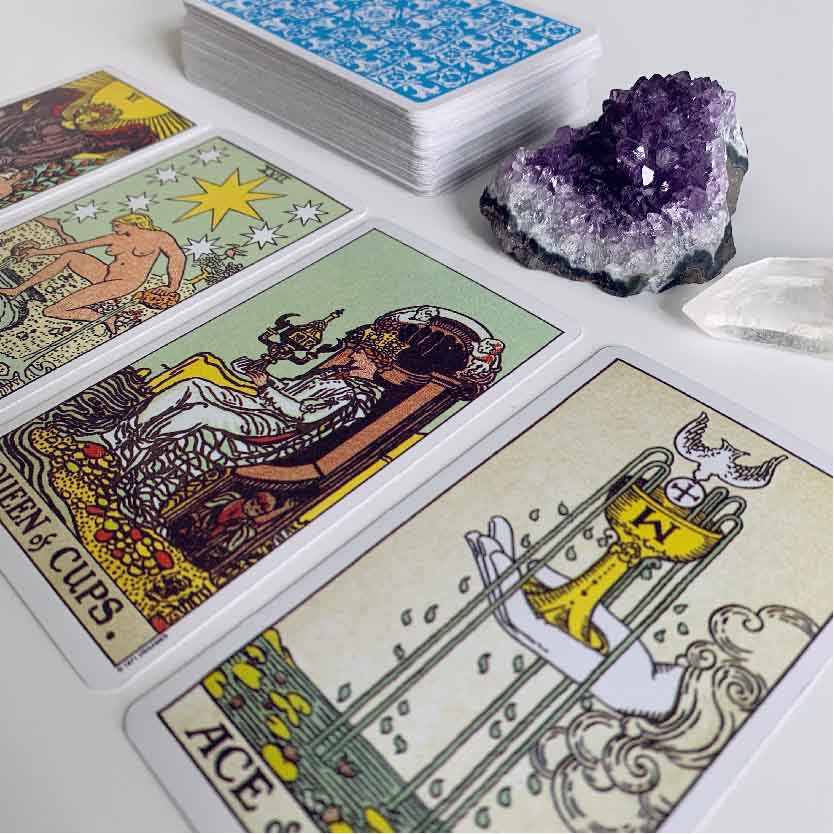4 card tarot reading for answering your question pictured with an amethyst and clear quartz
