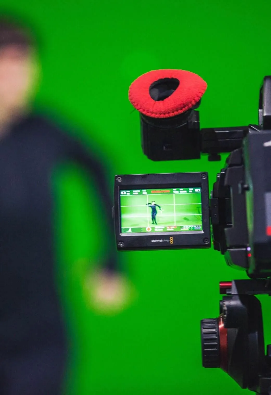 Camera filming an actor in a mocap suit