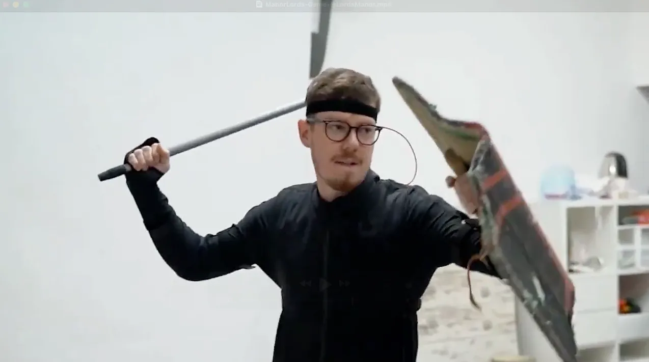 Rokoko creator wearing the Rokoko suit, a sword and shield prop while capturing motions for an indie game. 