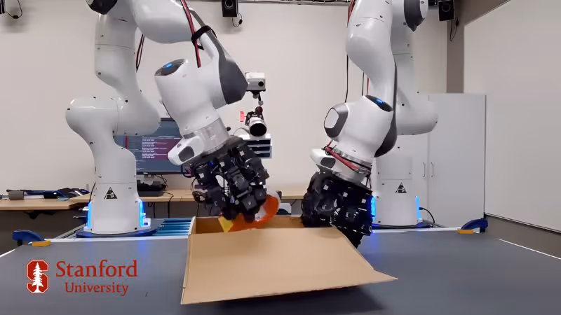 Two robot hands putting items into a cardboard box showcasing that its possible to train robots with Rokoko Smartgloves to do repetitive tasks