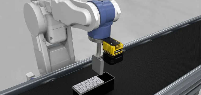 Industrial robotic arm automating assembly on a conveyor belt, representing the best robotics stocks.