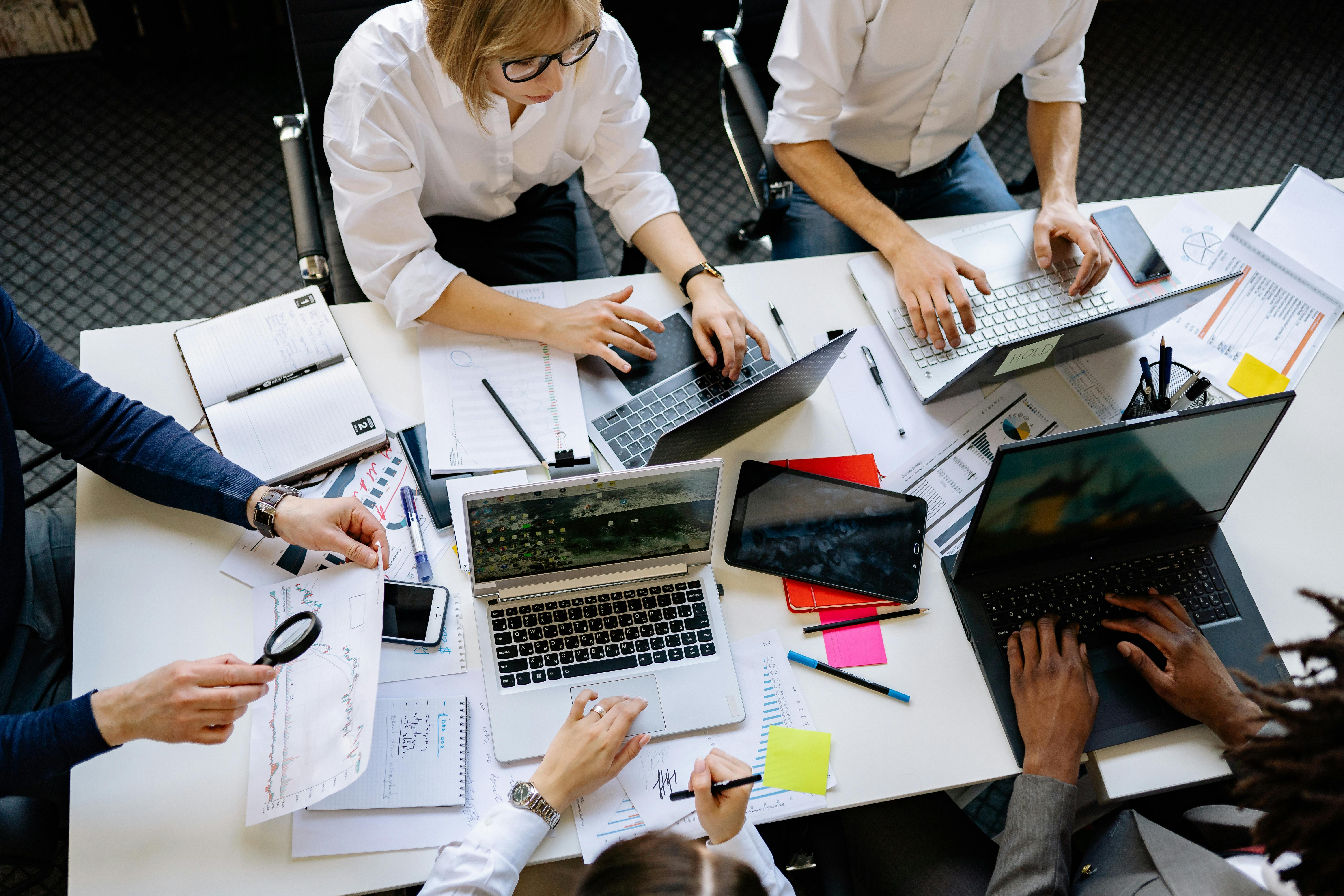 A team working together in an office around a desk. 