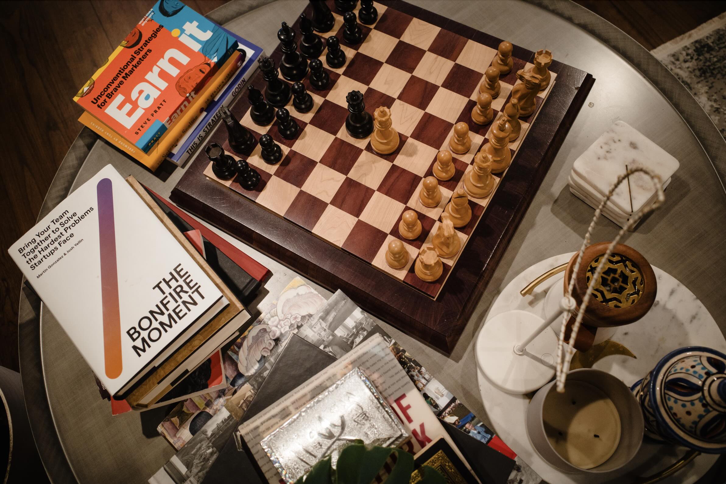 A close-up of a desk with a coffee cup, notebook, and a laptop, symbolizing productivity and work-focused activities in an office environment.