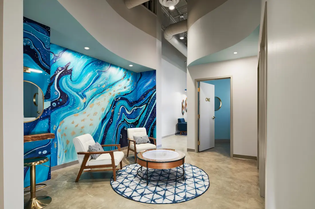 Waiting lounge with geode mural at sek Sauna Studio