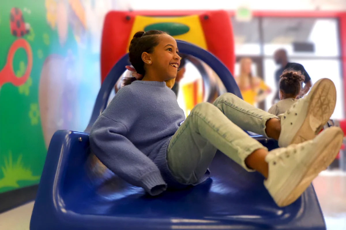 Two little girls playing with balloons in Cookie Cutters