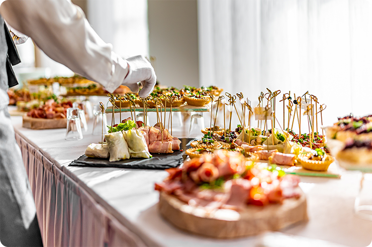 A public speaker presenting to a seated audience on white chairs