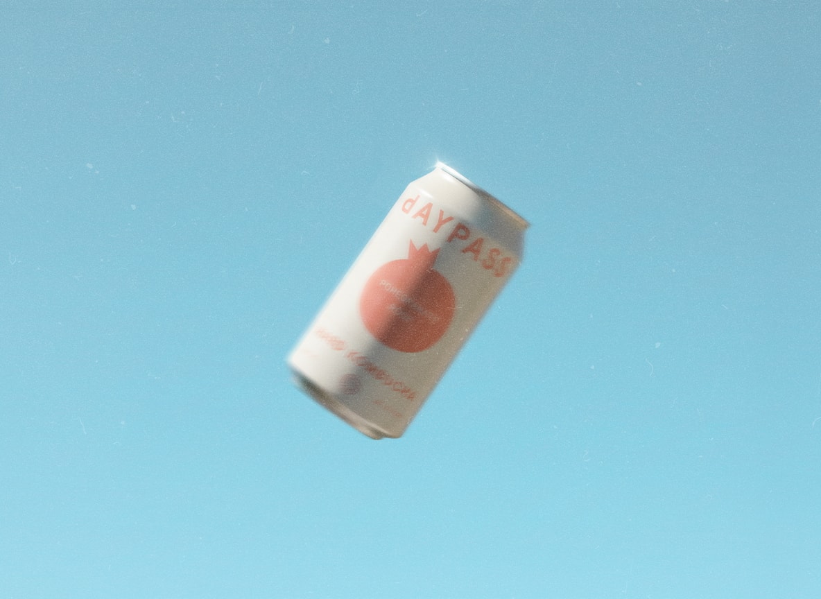 Daypass can floating in the air against a bright blue sky