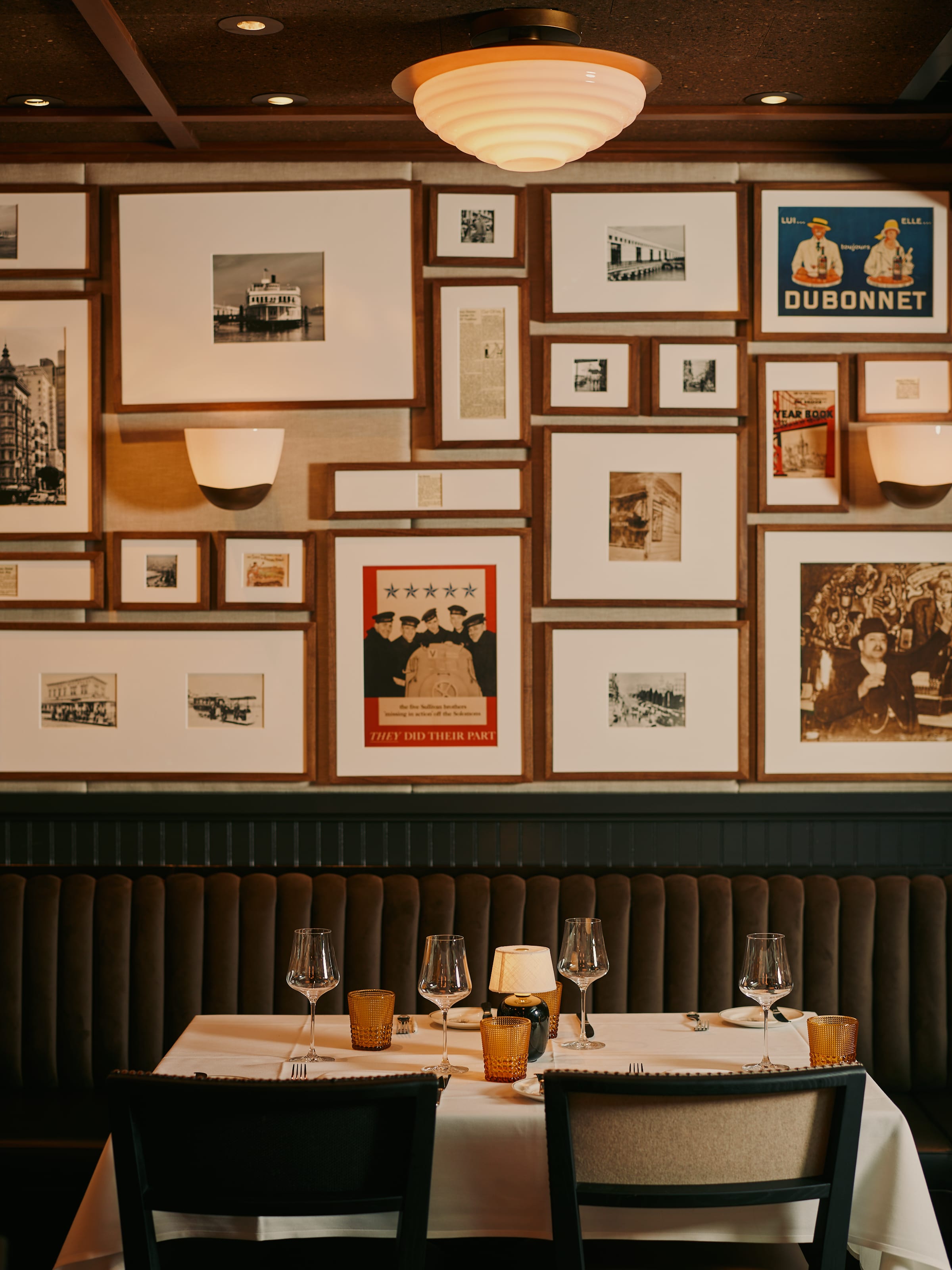 Two-seat dining table in the candlelit Izzy's gallery wall dining room